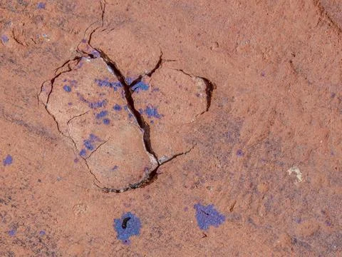 Cracks and marks on rustic clay floor tiles forming a broken heart shape Stock Photos