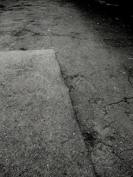 Cracks in the asphalt. Grunge background of broken asphalt. A crumbling old.. Foto stock
