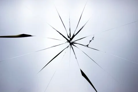 Cracks on broken glass. Abstraction pattern on the window. Stock Photos