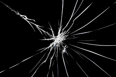 Cracks on broken glass. Abstraction pattern on the window. Stock Photos