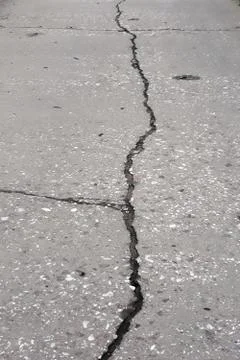 Cracks on concrete road. Stock Photos