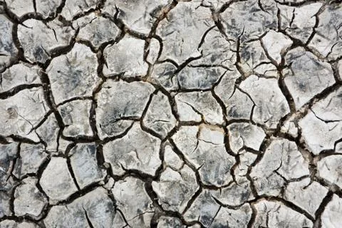 Cracks in dried mud in estuary, background Stock Photos