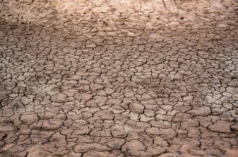 Cracks in the dry ground background Stock Photos