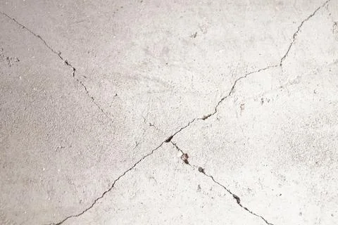 Cracks on the gray wall in shape of cross. Stock Photos