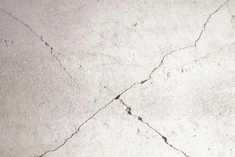 Cracks on the gray wall in shape of cross. Stock Photos