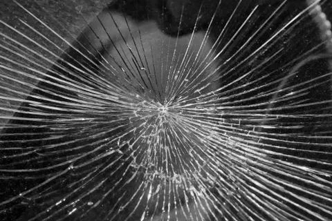 Cracks from the impact on the windshield of the car. Stock Photos