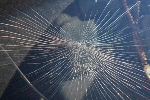 Cracks from the impact on the windshield of the car. Stock Photos