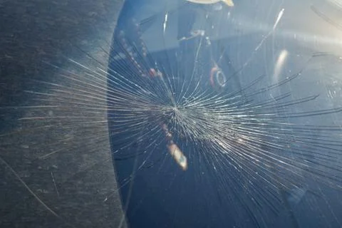Cracks from the impact on the windshield of the car. Stock Photos