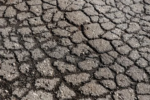 Cracks on the old asphalted road Stock Photos