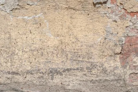 Cracks in old plaster wall, chipped paint, beige texture, background Stock Photos