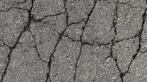 Cracks in specialized road surface. Structured, background image Stock Photos