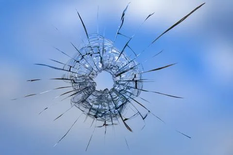 Cracks in the window glass on a background of sky. Stock Photos