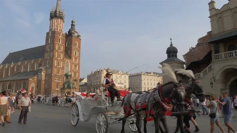 Cracow, Krakow, Poland. Old town, horse cab and St. Mary church Stock Footage