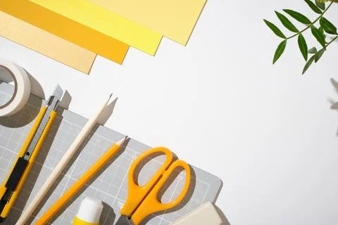 Craft and design background with tools and yellow office supplies. Copy space Stock Photos
