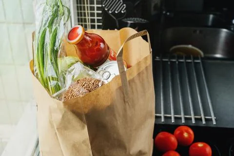 Craft bag with groceries on the kitchen surface Stock Photos
