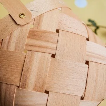 Craft basket with an interesting pattern. Spring decor, details. Eco style. Stock Photos