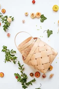 Craft baskets on spring background with flowers and greenery. The concept o.. Stock Photos
