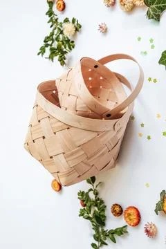 Craft baskets on spring background with flowers and greenery. The concept o.. Stock Photos