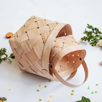 Craft baskets on spring background with flowers and greenery. The concept o.. Stock Photos