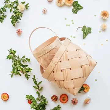 Craft baskets on spring background with flowers and greenery. The concept o.. Stock Photos