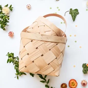 Craft baskets on spring background with flowers and greenery. The concept o.. Stock Photos
