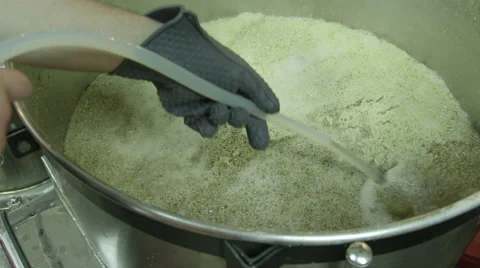 Craft Beer Brewer Working Over Large Brew Kettle at Brewery Vídeo Stock 61502304