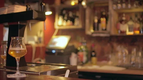 Craft Beer Glass on Counter with Draft Taps and Blurred Back Bar Stock Footage 346236464