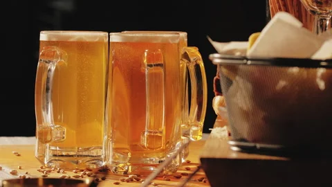Craft beer in mugs with snacks. Closeup Stock Footage 240184008