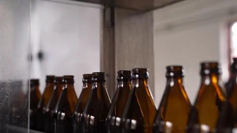 Craft beer production. Conveyor with empty bottles. Stock Footage 256181571