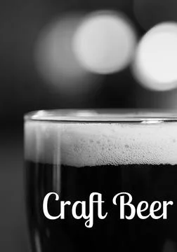 Craft beer text over close up of beer class against black background Stock Photos