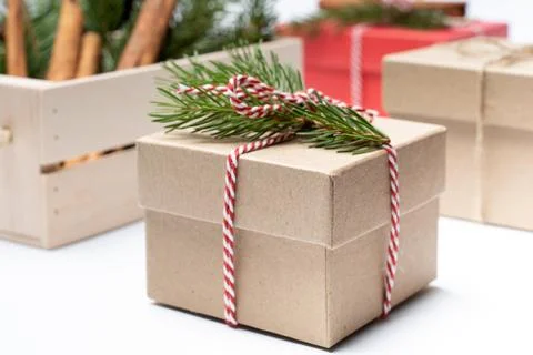 Craft box with pine tree branch, white and red rope holidays boxes background Stock Photos