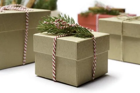 Craft box with pine tree branch, white and red rope holidays boxes background Stock Photos