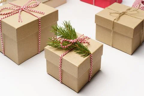 Craft box with pine tree branch, white and red rope holidays boxes background Stock Photos