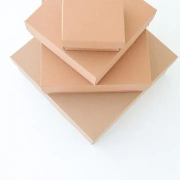 Craft boxes on a white background are stacked on top of each other. Place f.. Stock Photos