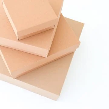 Craft boxes on a white background are stacked on top of each other. Place f.. Stock Photos