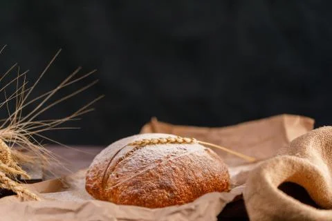 Craft bread and spikelets close-up on a dark background. The concept of healt Stock Photos