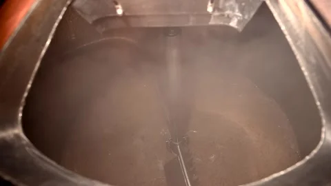 Craft Brewery Process of Brewing Beer in Slow Motion With Steam and Malt at a Stock Footage 323917600