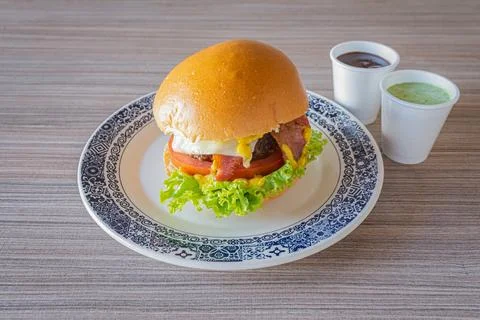 Craft burger served with dipping sauces still life Foto stock