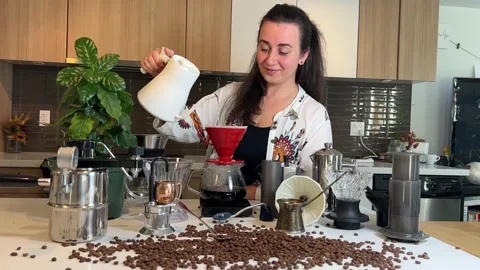 Craft coffee ad In foreground coffee beans are scattered on the table Different Stock Footage 220697739