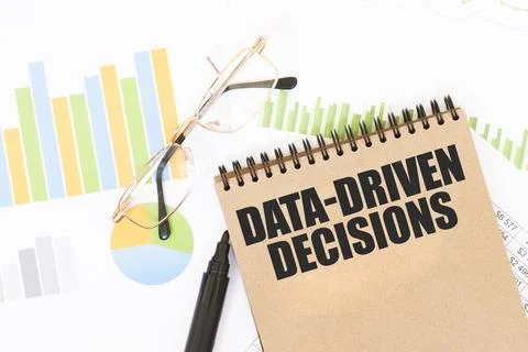 In a craft colour notebook is a DATA-DRIVEN DECISIONS inscription, next to .. Stock Photos