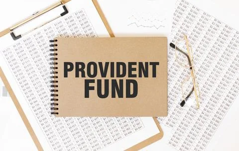 Craft colour notepad with text PROVIDENT FUND. Notepad with eyeglasses and .. Stock Photos