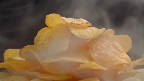 Craft crispy hot potato chips with smoke rotating on Stock Footage 196830522