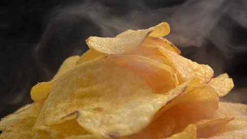 Craft crispy hot potato chips with smoke rotating on Stock Footage 196830527