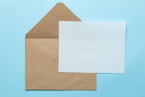 Craft envelope and blank for text on a bright trendy light blue background. t Stock Photos