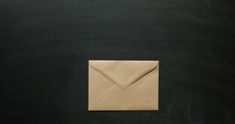 A craft envelope and a clean sheet of white paper comes out of it Stock Footage 203878484