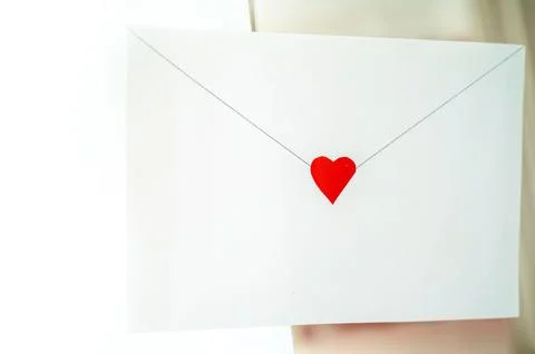 Craft envelope made of white paper with a small cute heart Stock Photos