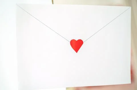 Craft envelope made of white paper with a small cute heart Stock Photos
