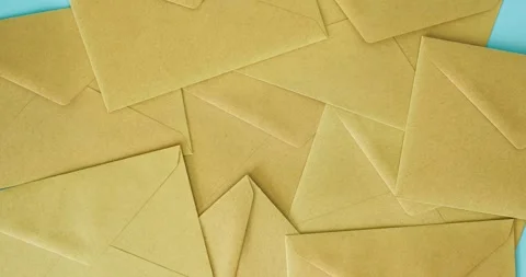 Craft envelopes for letters on a blue background. 4K stop motion animation Vídeos de archivo 344844363