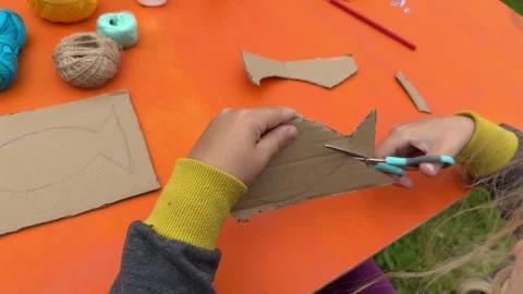 Craft a fish out of cardboard, thread, and paint Stock Footage 320496442