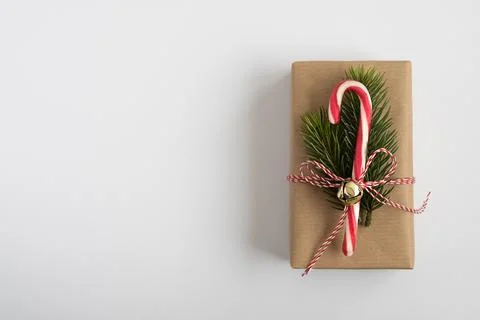 Craft gift box with candy cane, Christmas tree and jingle bell Stock Photos